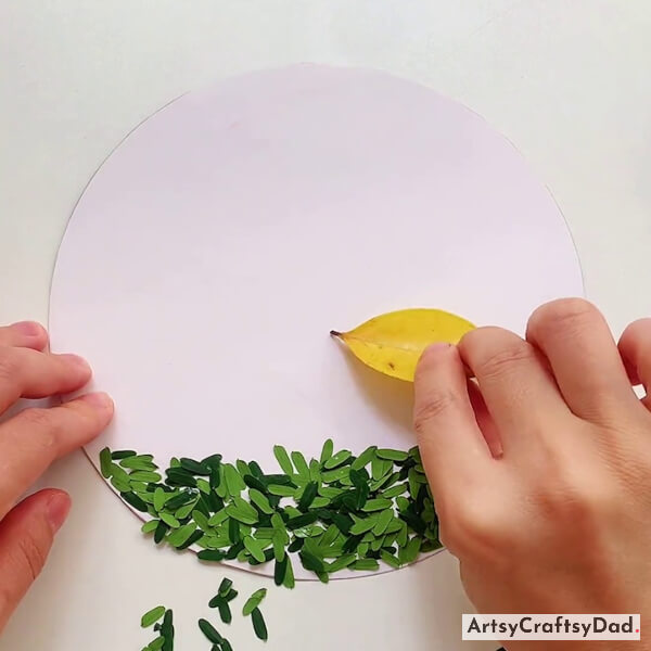 Pasting Yellow Leaves on White Circle Paper