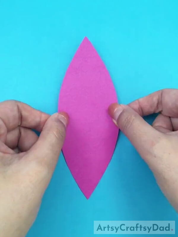 Cutting a Pink Craft Paper in Leaf Shape