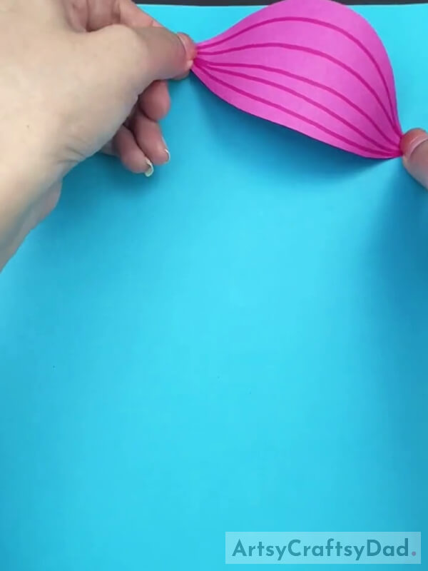 Pasting Leaf Shape on a Blue Craft Paper