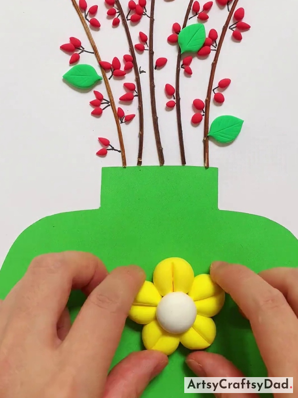 Pasting Yellow Color Clay Flower on Paper Pot