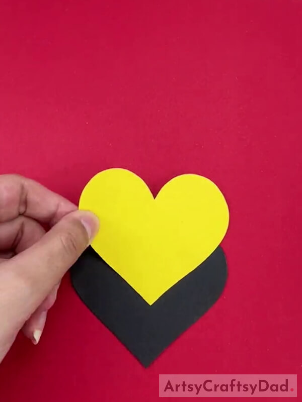 Pasting Heart Shaped Yellow Paper on Black Heart Shaped Paper