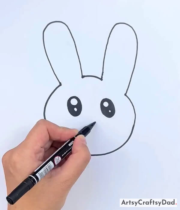 Drawing The Eyes And Nose Of The Rabbit