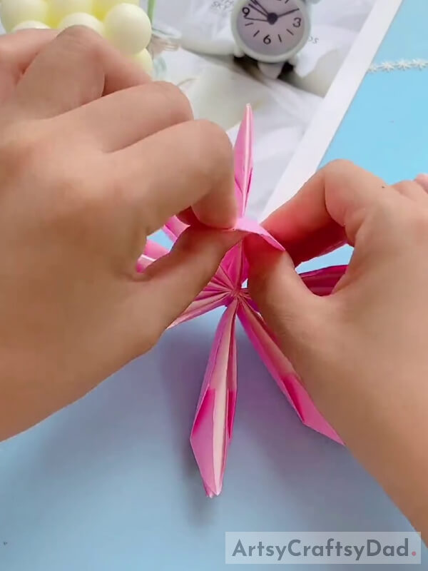 Unfolding Pink Paper to Make Petals