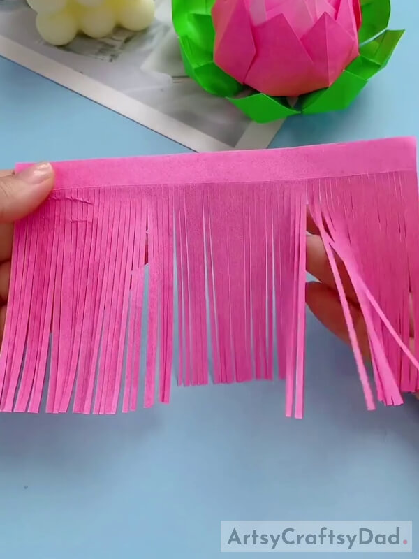 Cutting Another Pink Paper in Thin Stripes