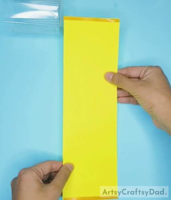 Taking Yellow Paper of the Same Size as Bottle