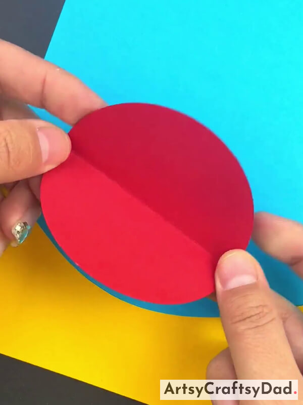Folding Red Circle To Make Creases