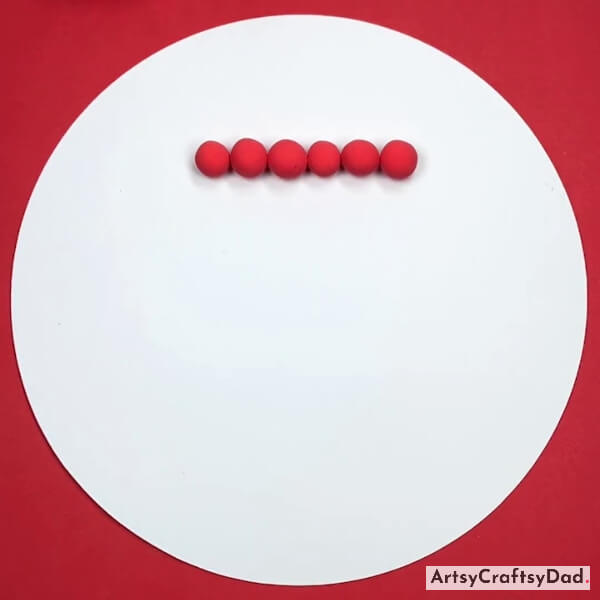 Pasting Clay Balls On A Craft Paper