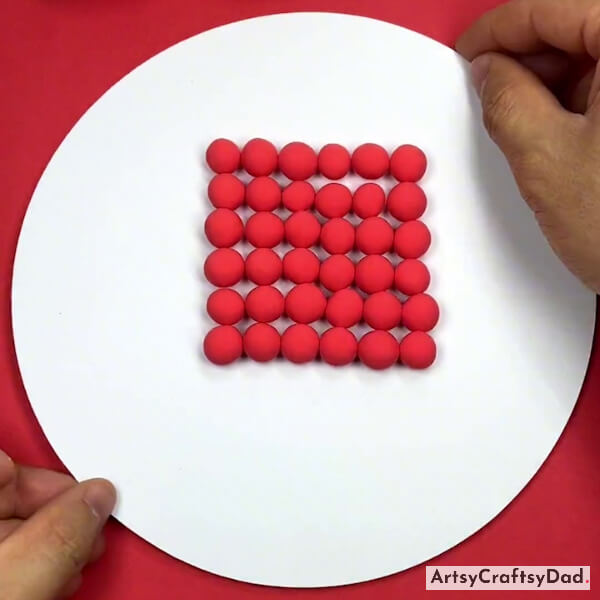 Completing Pasting Clay Balls in a Square Shape