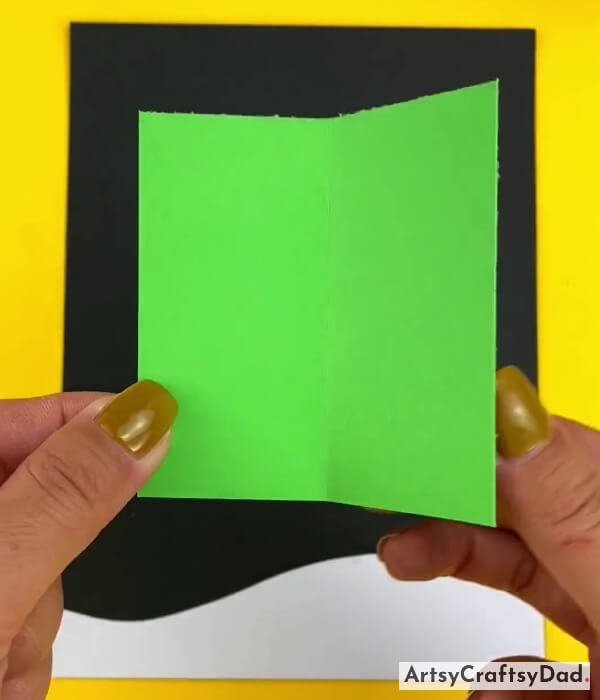 Folding The Green Paper To Make Creases
