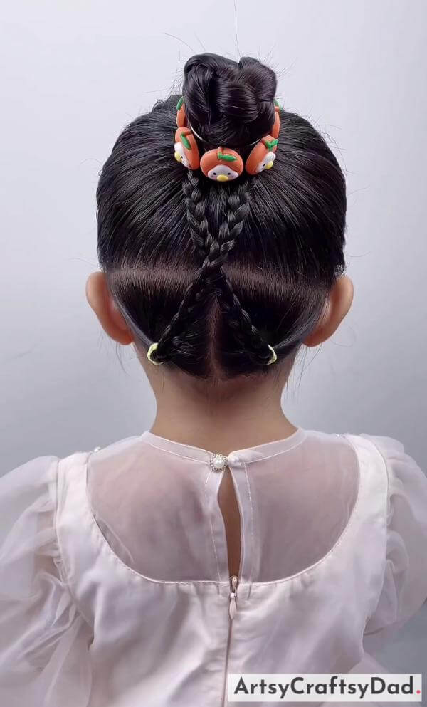 Amazing Braided Bun Hairstyle for Kids-Adorable hairclips and a bun hairstyle for children.