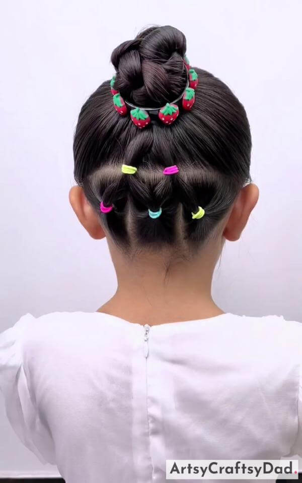 A Colorful Beads Braided Bun Hairstyle for Kids-Kids' braided bun hairstyle with adorable hair clips.