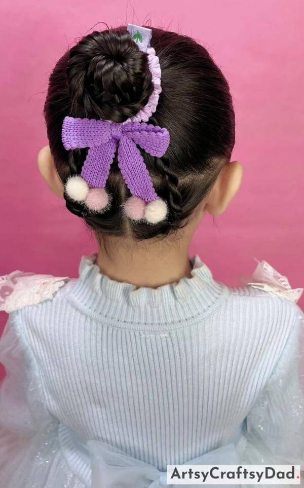 A Cute Twisted Bun Hairstyle for Kids-Adorable hair accessories for kids' braided bun hairstyles.