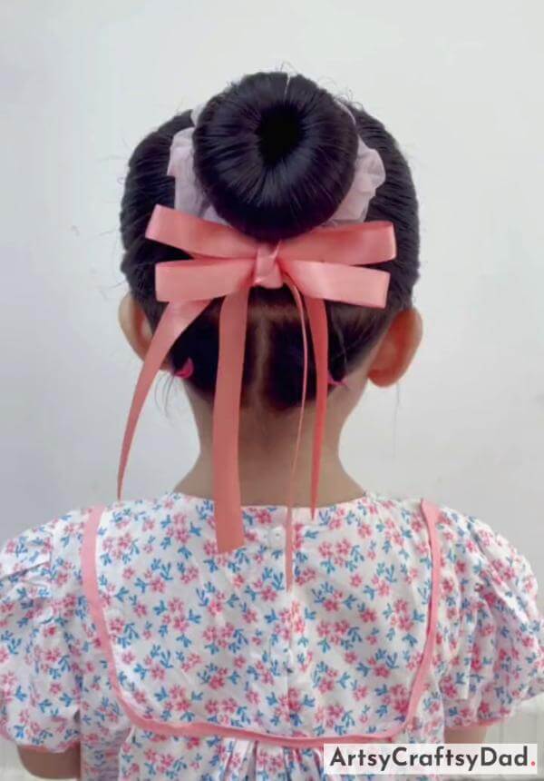 A Simple Ribbon Bun Hairstyle for Kids-Delightful hair accessories and a bun hairstyle for children.
