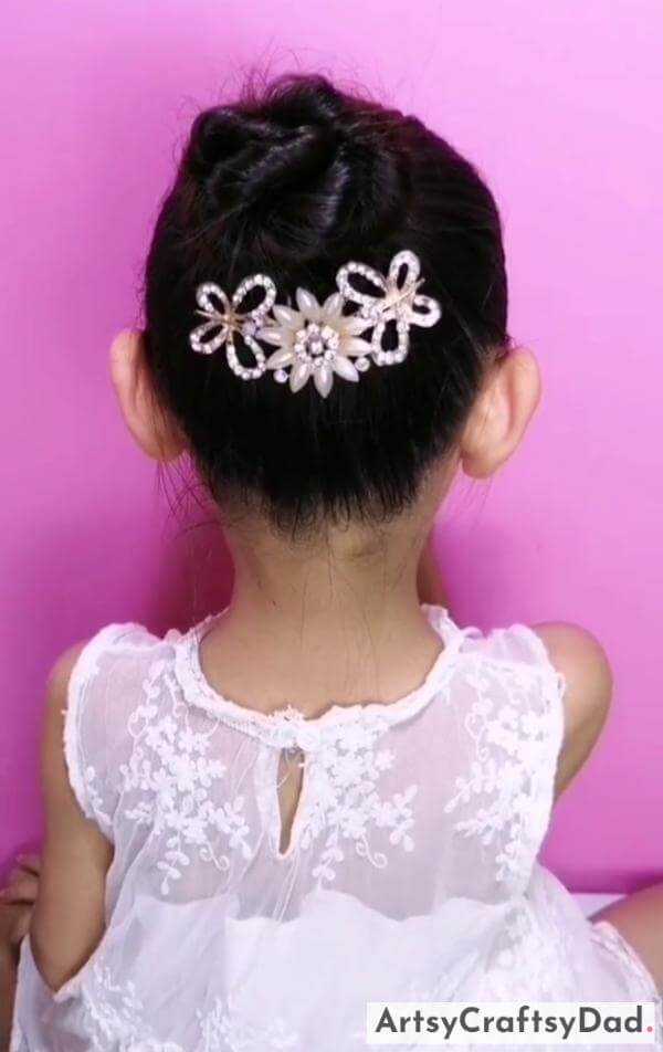 Beautiful Twisted Bun Hairstyle With Glitter Clips-Pretty hair accessories and a braided bun hairstyle for kids.