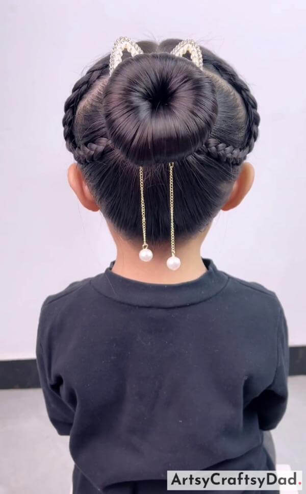 Cutest Dual Braids Bun Hairstyle for Kids-Attractive hair accessories and a bun hairstyle for kids.