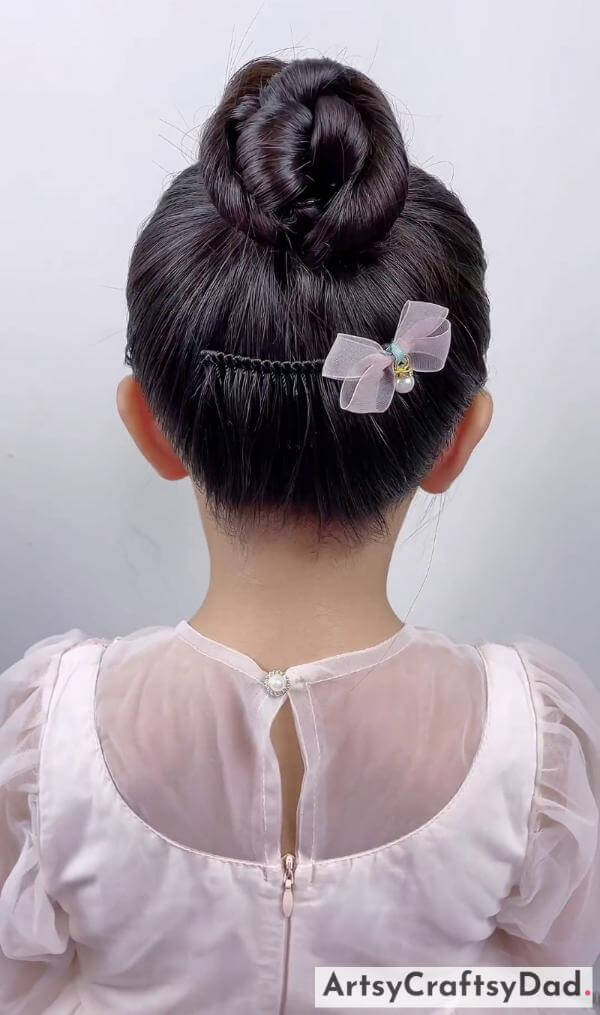 Simple Bow Bun Hairstyle for Kids-Charming hair adornments for kids' braided bun hairdo
