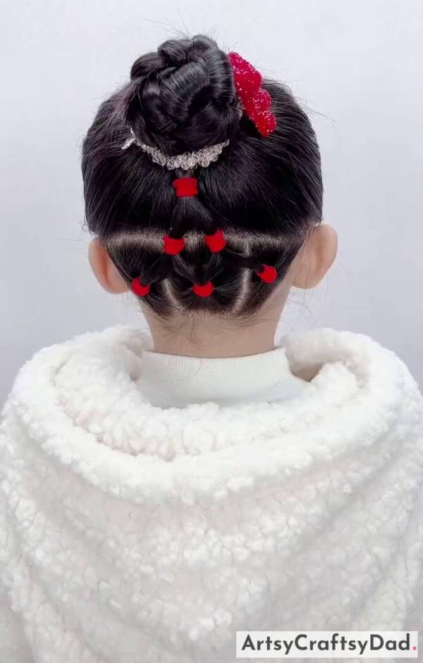 Simple Tight Braided Bun Hairstyle With Red Beads- Delightful hair decorations for kids' braided bun look