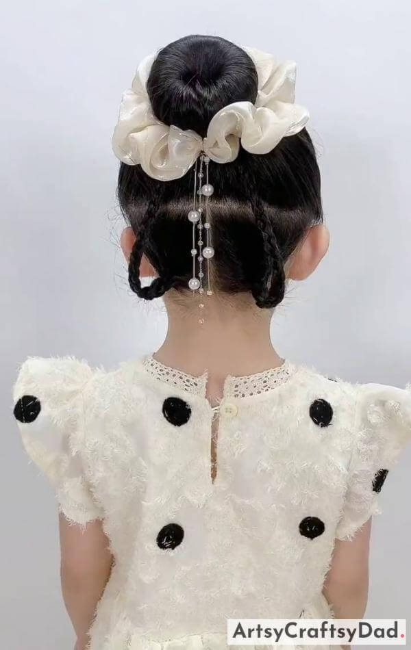 Stylish Braided Bun Hairstyle With Flower Rubber Band-Pretty hair embellishments for children's braided bun hairdo