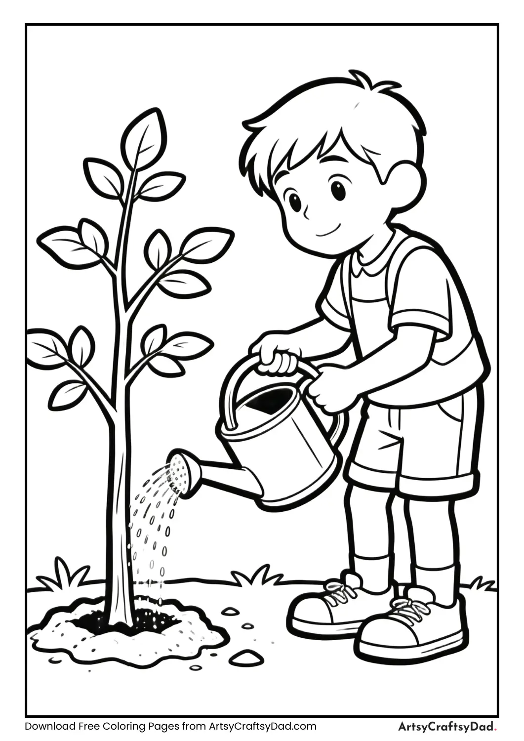 Boy watering a newly planted tree with a watering can